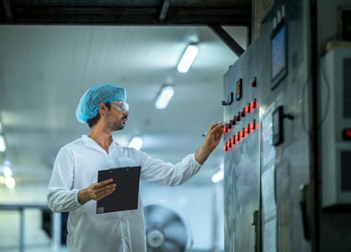 FSMA 204 Compliance Delay - Factory Worker Inspecting Control Panel